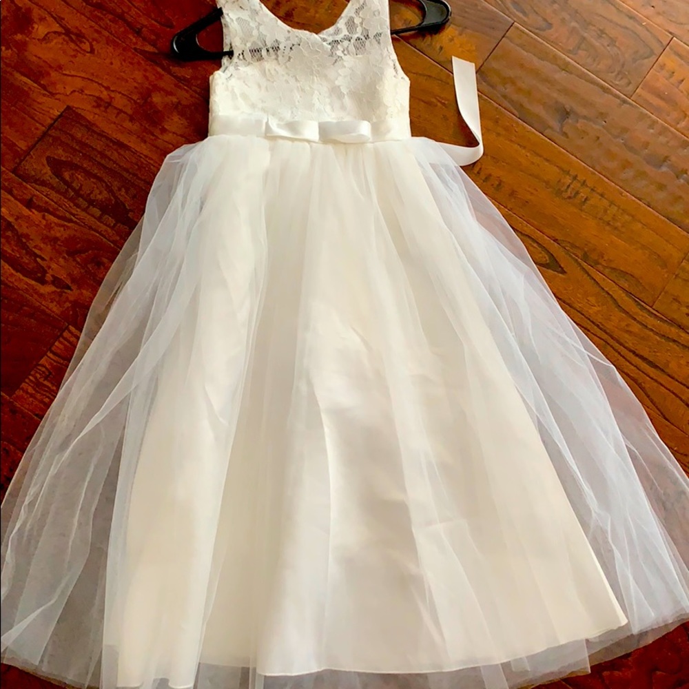 Formal child’s dress in white with lace bodice.